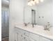 Bathroom with double sinks, white cabinets and a large mirror with overhead lighting at 9404 Dawnshire Rd, Raleigh, NC 27615