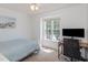 Bright bedroom with a comfortable bed, a large window and a work space with a dark chair at 9404 Dawnshire Rd, Raleigh, NC 27615