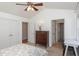Bedroom featuring vaulted ceiling, ceiling fan and views into adjacent bathroom and office at 9404 Dawnshire Rd, Raleigh, NC 27615