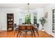 Dining area featuring large windows, modern lighting, and seating for six at 9404 Dawnshire Rd, Raleigh, NC 27615