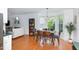 Dining area adjacent to the living room, featuring a dark wood table and hardwood floors at 9404 Dawnshire Rd, Raleigh, NC 27615