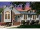 Charming home featuring a brick and siding exterior, front porch, and well-maintained landscaping at 9404 Dawnshire Rd, Raleigh, NC 27615