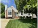 Charming home featuring a well-manicured lawn, inviting entryway, and blossoming landscaping at 9404 Dawnshire Rd, Raleigh, NC 27615