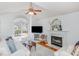 Bright living room featuring a fireplace, hardwood floors, and a large window at 9404 Dawnshire Rd, Raleigh, NC 27615