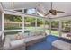 Relax in this inviting sunroom with comfortable seating, ceiling fan, and views of the lush backyard at 9404 Dawnshire Rd, Raleigh, NC 27615