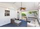 Enjoy this well-lit sunroom with cozy furniture and a ceiling fan at 9404 Dawnshire Rd, Raleigh, NC 27615