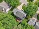 Bird's-eye perspective of a home with a deck, nestled among trees and adjacent properties, highlighting the lot's privacy at 104 Montauk Point Pl, Cary, NC 27513