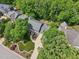 Overhead view of a home surrounded by mature trees, showcasing its landscaped yard, curved driveway, and proximity to neighbors at 104 Montauk Point Pl, Cary, NC 27513