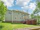 Two-story home's exterior showcasing a well-manicured lawn and a multi-tiered deck, ideal for outdoor gatherings at 104 Montauk Point Pl, Cary, NC 27513