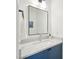 Bright bathroom featuring a blue vanity cabinet and a modern square mirror at 104 Montauk Point Pl, Cary, NC 27513