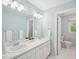 Bright bathroom with double sinks, white cabinetry and ample lighting at 104 Montauk Point Pl, Cary, NC 27513
