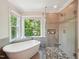 Bathroom featuring a freestanding tub and a luxurious glass-enclosed shower at 104 Montauk Point Pl, Cary, NC 27513