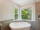 Bathroom featuring a freestanding tub and a luxurious glass-enclosed shower at 104 Montauk Point Pl, Cary, NC 27513