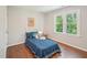 Comfortable bedroom featuring hardwood floors, natural light and a sunny yellow theme at 104 Montauk Point Pl, Cary, NC 27513