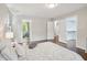 Bright bedroom featuring hardwood floors, walk-in closet, and en suite bathroom with tub at 104 Montauk Point Pl, Cary, NC 27513