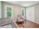Cozy Bedroom with a crib, rocking chair, hardwood floors and natural light at 104 Montauk Point Pl, Cary, NC 27513