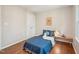 Comfortable bedroom featuring hardwood floors, natural light and a sunny yellow theme at 104 Montauk Point Pl, Cary, NC 27513