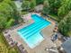 Aerial view of a community pool with lounge chairs, surrounded by a black metal fence at 104 Montauk Point Pl, Cary, NC 27513