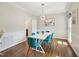 Elegant dining room with modern chandelier, white wainscoting, and hardwood floors at 104 Montauk Point Pl, Cary, NC 27513