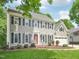 Well-maintained two-story house with gray siding, black shutters, and a manicured front lawn at 104 Montauk Point Pl, Cary, NC 27513