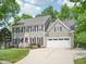 Charming two-story house featuring gray siding, black shutters, and an attached two-car garage at 104 Montauk Point Pl, Cary, NC 27513