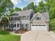 Attractive two-story home boasting gray siding, black shutters, and an attached two-car garage at 104 Montauk Point Pl, Cary, NC 27513