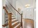 Inviting foyer featuring hardwood floors, a staircase, and ample natural light at 104 Montauk Point Pl, Cary, NC 27513
