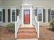 Welcoming front entrance with a red door, white trim, and brick steps at 104 Montauk Point Pl, Cary, NC 27513