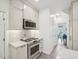Well-lit kitchen with stainless steel range, quartz countertops and white subway tile at 104 Montauk Point Pl, Cary, NC 27513