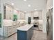 Modern kitchen with custom cabinets, stainless appliances, and center island at 104 Montauk Point Pl, Cary, NC 27513