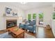 Inviting living room with a brick fireplace, French doors and a cozy seating area at 104 Montauk Point Pl, Cary, NC 27513