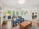 Comfortable living room with fireplace, seating, and views of the deck and kitchen at 104 Montauk Point Pl, Cary, NC 27513
