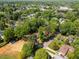Aerial view showcases the tree-lined neighborhood and the property's proximity to town at 106 Circle Dr, Mebane, NC 27302