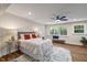 Comfortable bedroom featuring a ceiling fan, large windows, and stylish decor for a relaxing retreat at 106 Circle Dr, Mebane, NC 27302