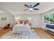 Well-lit bedroom boasts a ceiling fan, natural light, and calming atmosphere, perfect for restful nights at 106 Circle Dr, Mebane, NC 27302