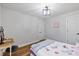 Bedroom featuring hardwood floors, a decorative desk, and an inviting, comfortable space at 106 Circle Dr, Mebane, NC 27302
