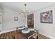 Dining room with view of kitchen, modern table, and stylish light fixture at 106 Circle Dr, Mebane, NC 27302