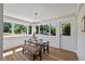Dining room with view of backyard, modern table, and stylish light fixture at 106 Circle Dr, Mebane, NC 27302