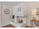 Cozy white brick fireplace with a decorative mantel and wood-look floors at 106 Circle Dr, Mebane, NC 27302