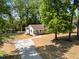 Well-maintained home featuring a long driveway and manicured lawn and mature shade trees at 106 Circle Dr, Mebane, NC 27302