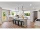 Open kitchen with island, sleek counter tops, barstool seating, and stainless-steel appliances at 106 Circle Dr, Mebane, NC 27302