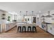 Renovated kitchen with stainless steel appliances, marble countertops, and a breakfast bar with seating at 106 Circle Dr, Mebane, NC 27302