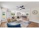 Open-concept living room featuring a modern ceiling fan and an airy kitchen with a center island at 106 Circle Dr, Mebane, NC 27302