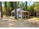 Charming backyard outbuilding with covered porch and architectural trim details at 106 Circle Dr, Mebane, NC 27302