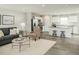 Inviting living room featuring an open floor plan, neutral decor, a kitchen island, and plenty of natural light at 111 N Coral Bells Way Way, Four Oaks, NC 27524