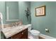 Stylish half bathroom with granite countertop, cherry cabinets and modern fixtures at 116 Hibiscus Dr, Clayton, NC 27527