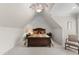 Cozy bedroom showcases a rich wood bed frame complemented by soft, neutral tones and an overhead ceiling fan at 116 Hibiscus Dr, Clayton, NC 27527