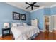 Bedroom features hardwood floors, blue walls and an ensuite bathroom at 116 Hibiscus Dr, Clayton, NC 27527