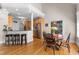 Eat-in kitchen with wooden floors, black chairs and table, and large windows at 116 Hibiscus Dr, Clayton, NC 27527