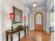 Inviting foyer with hardwood floors, decorative mirror, and elegant lighting at 116 Hibiscus Dr, Clayton, NC 27527